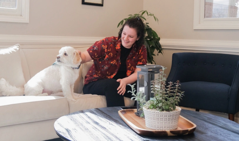 patient petting Strive Dental Studio's office dog