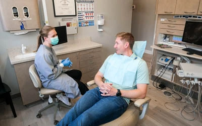 Dr. Fasone talking with a patient at Strive Dental Studio